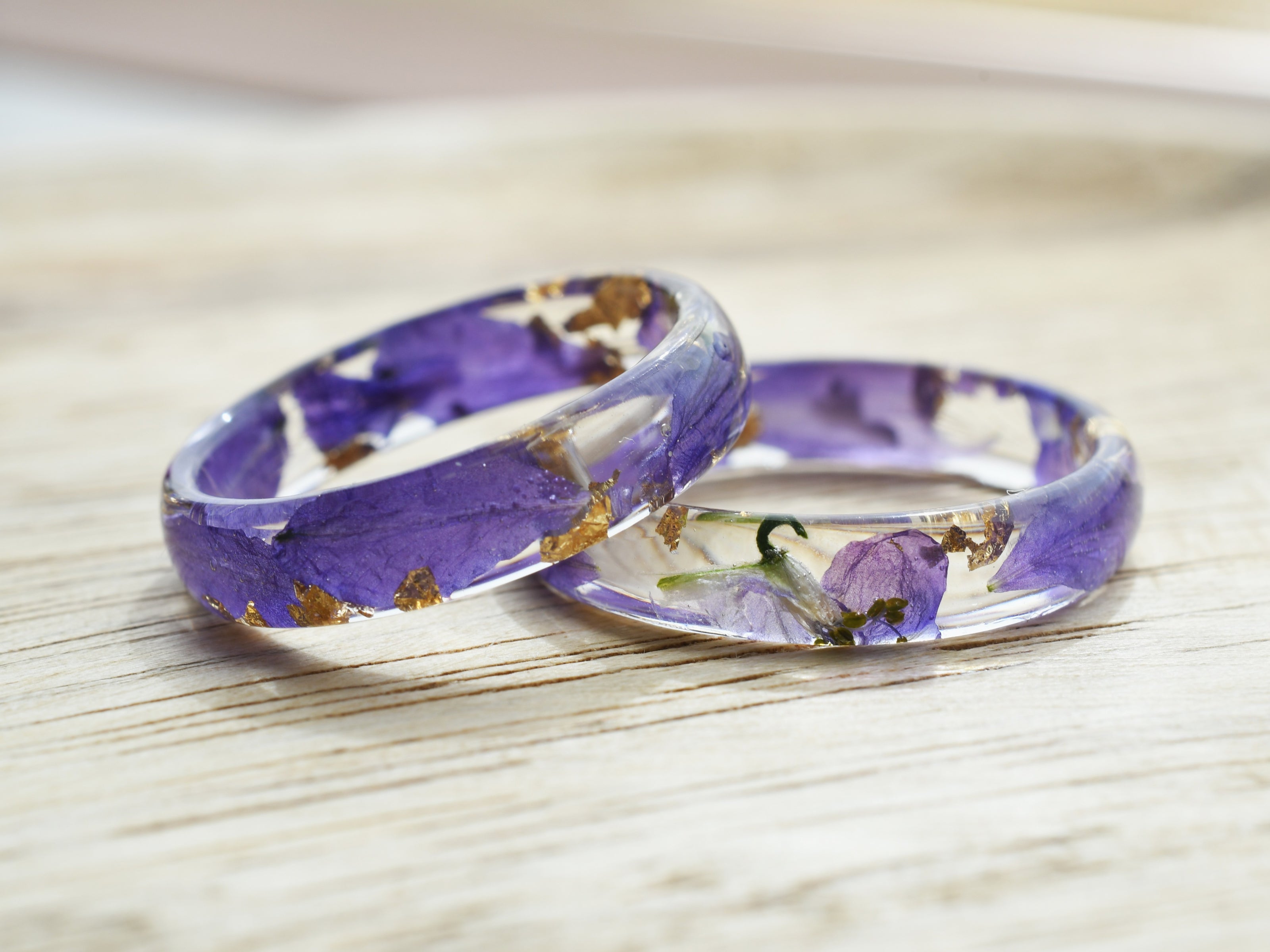 Close-up of the Larkspur Bloom Ring highlighting suspended petals and gold flecks