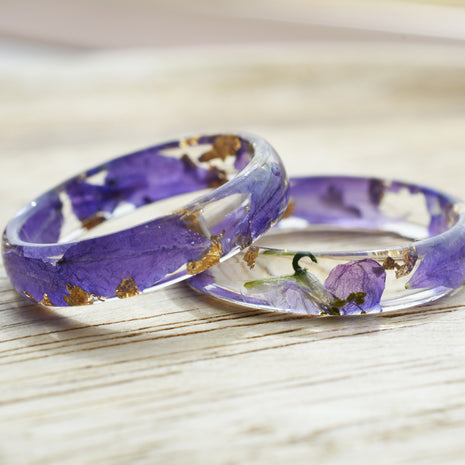 Close-up of the Larkspur Bloom Ring highlighting suspended petals and gold flecks