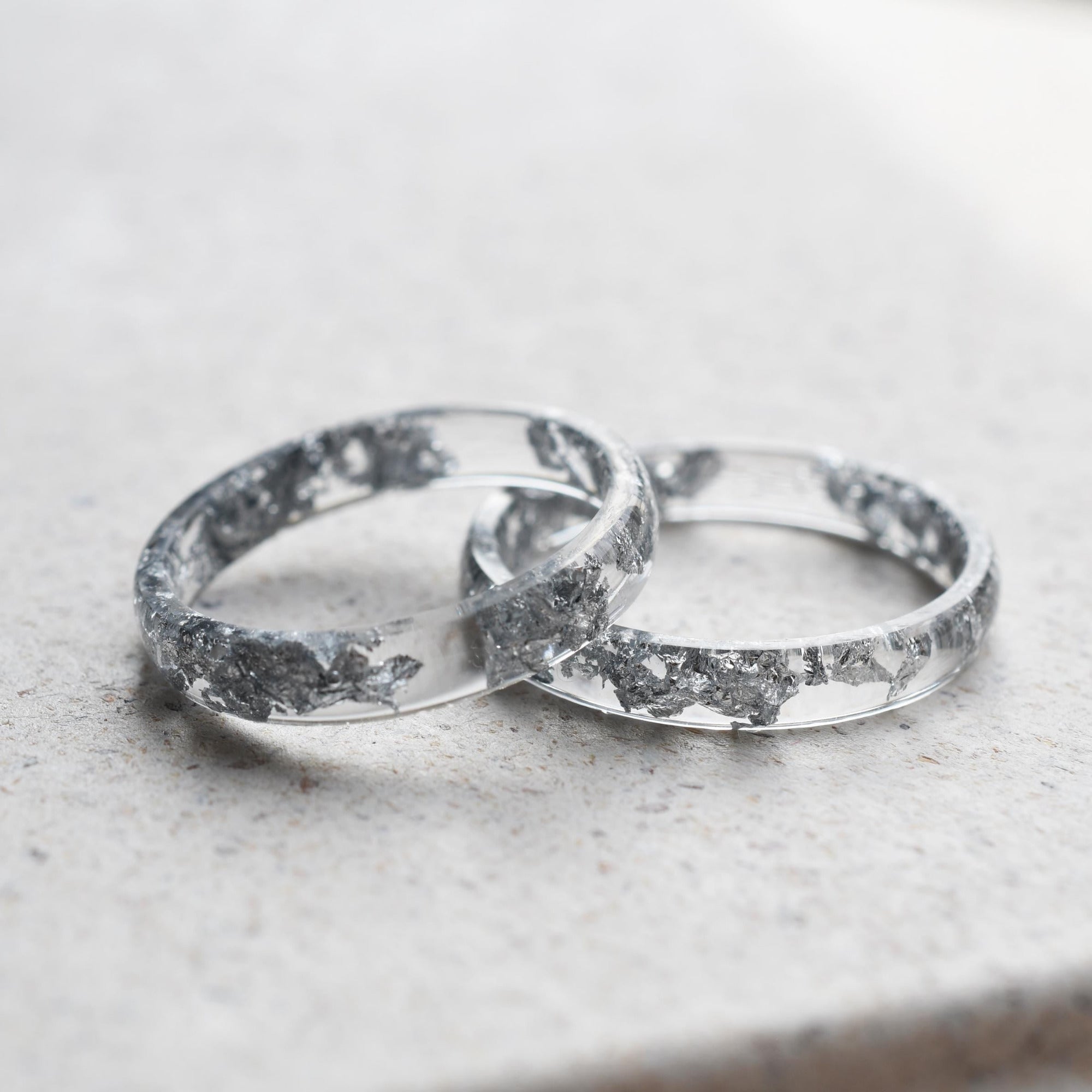 Side view of Lumen Ring showing its 4mm thin profile and shimmering silver detail