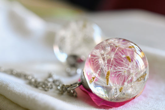 Close-up of resin pendant with dandelion seed