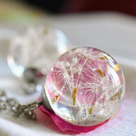 Close-up of resin pendant with dandelion seed