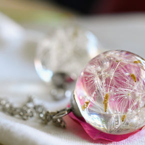 Close-up of resin pendant with dandelion seed