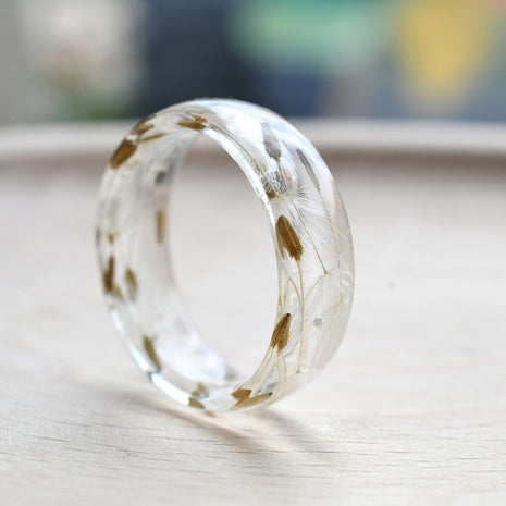 Flatlay of Make A Wish Ring showing dandelion seeds suspended in resin