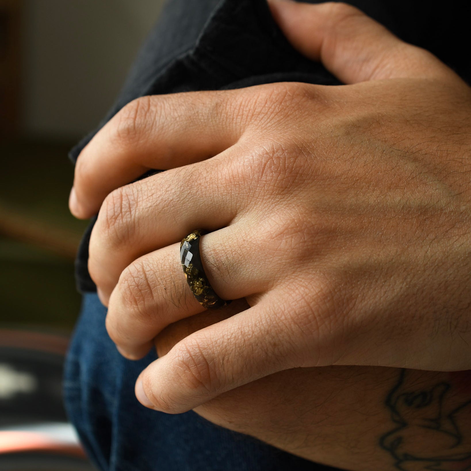 Minimalist black men’s ring with geometric faceted surface