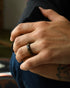 Minimalist black men’s ring with geometric faceted surface