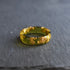 Minimalist olive men’s comfort-fit band with faceted surface