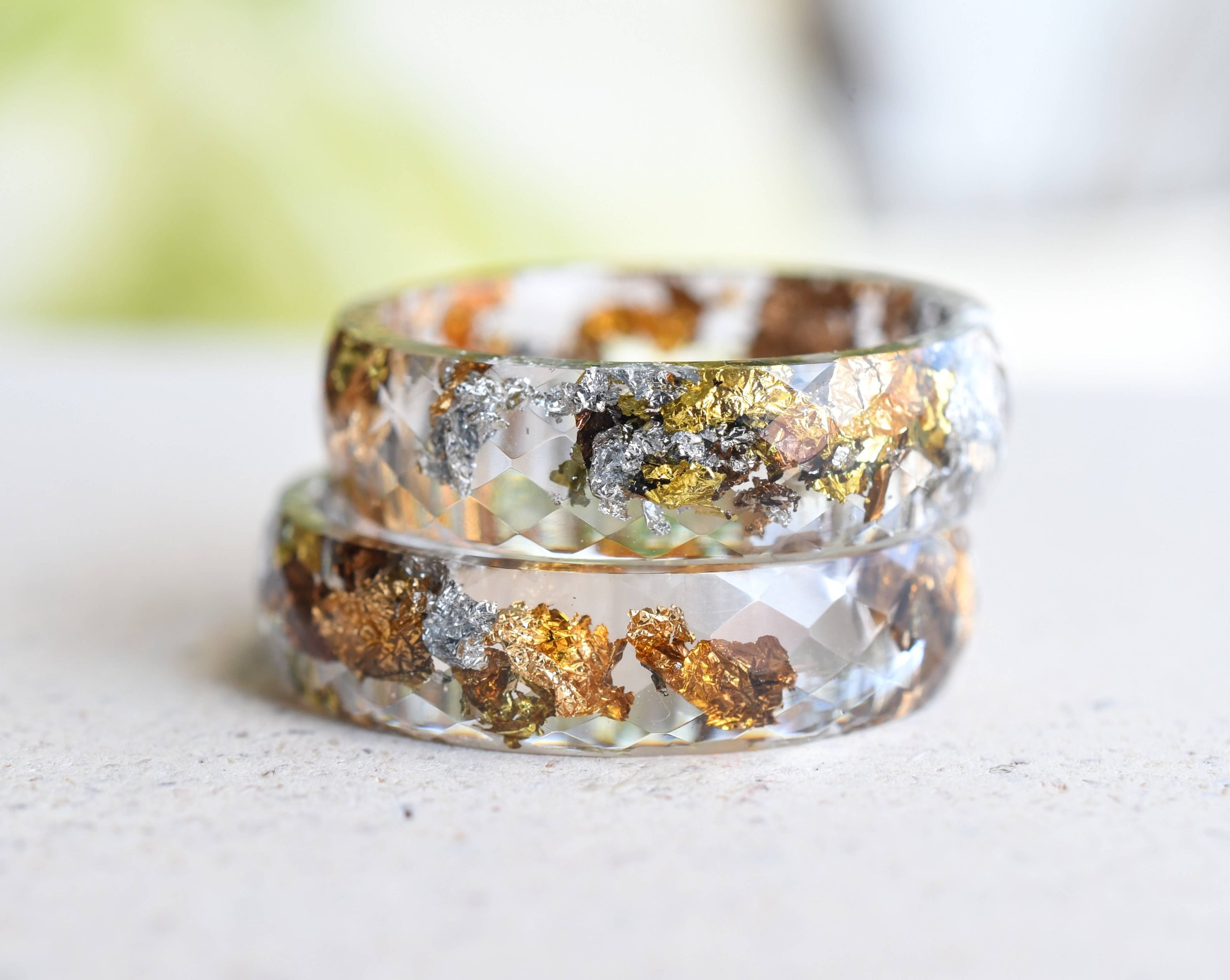 Close-up of metallic flakes suspended in clear resin handmade ring