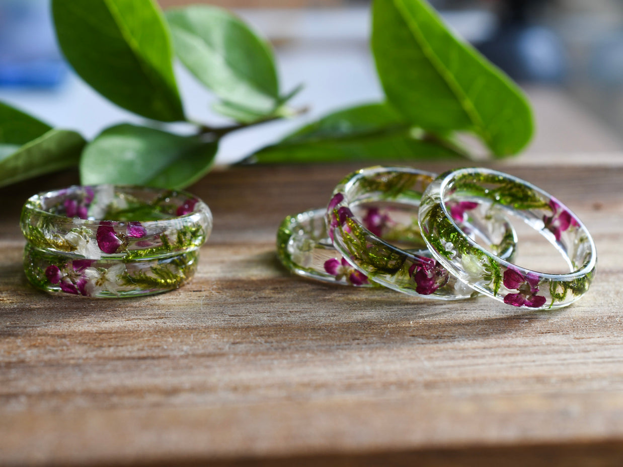 Close-up of real moss and alyssum preserved in clear resin ring