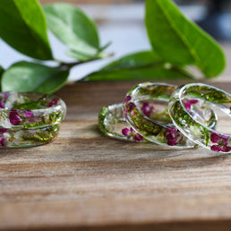 Close-up of real moss and alyssum preserved in clear resin ring