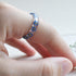 Nature-inspired resin band with blue flowers and metallic silver flakes
