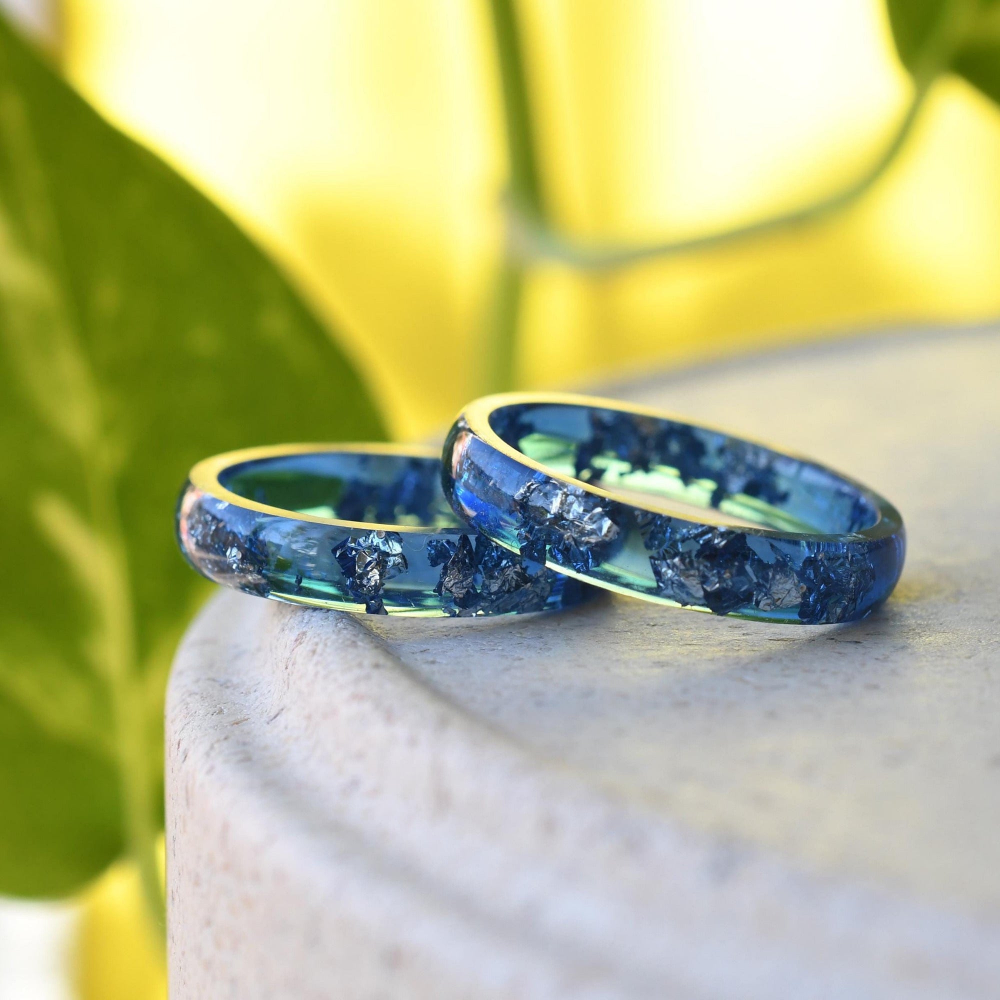 Navy blue resin ring with silver leaf on white background