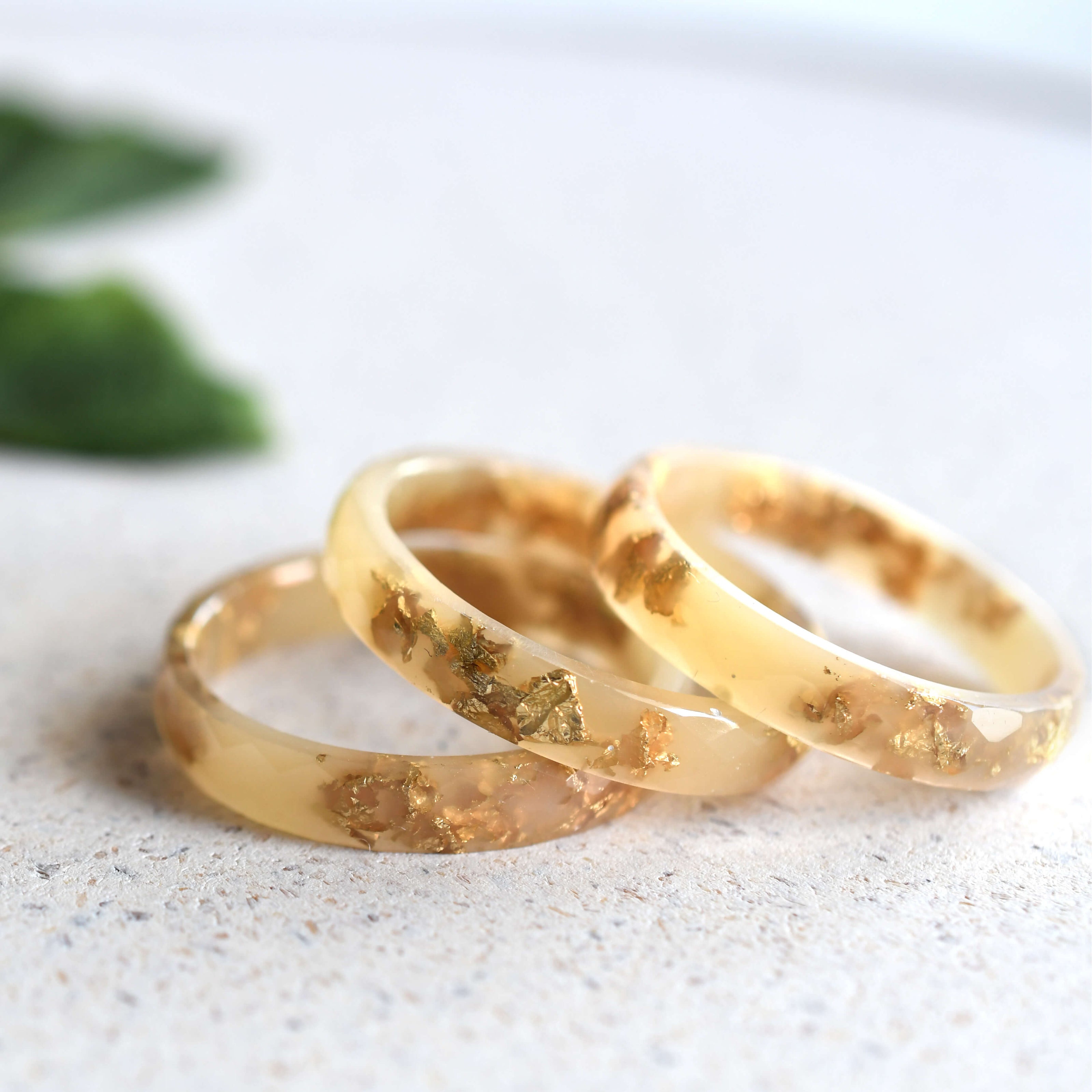 Nude resin ring with gold leaf on white background