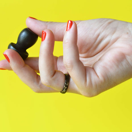 Obsidian black and gold resin ring worn on hand
