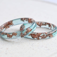 Handmade ocean blue resin ring with rose gold leaf detail — crafted in Vienna by Resity