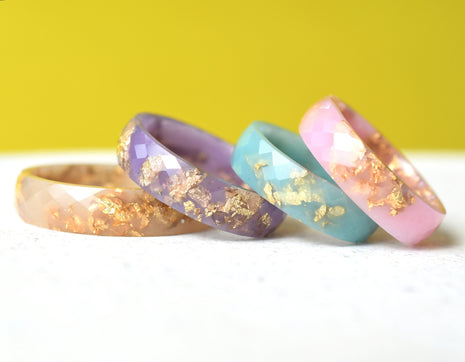 Faceted pastel resin rings with shimmering gold leaf — handmade jewelry
