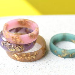 Close-up of gold flakes inside pastel resin handmade rings