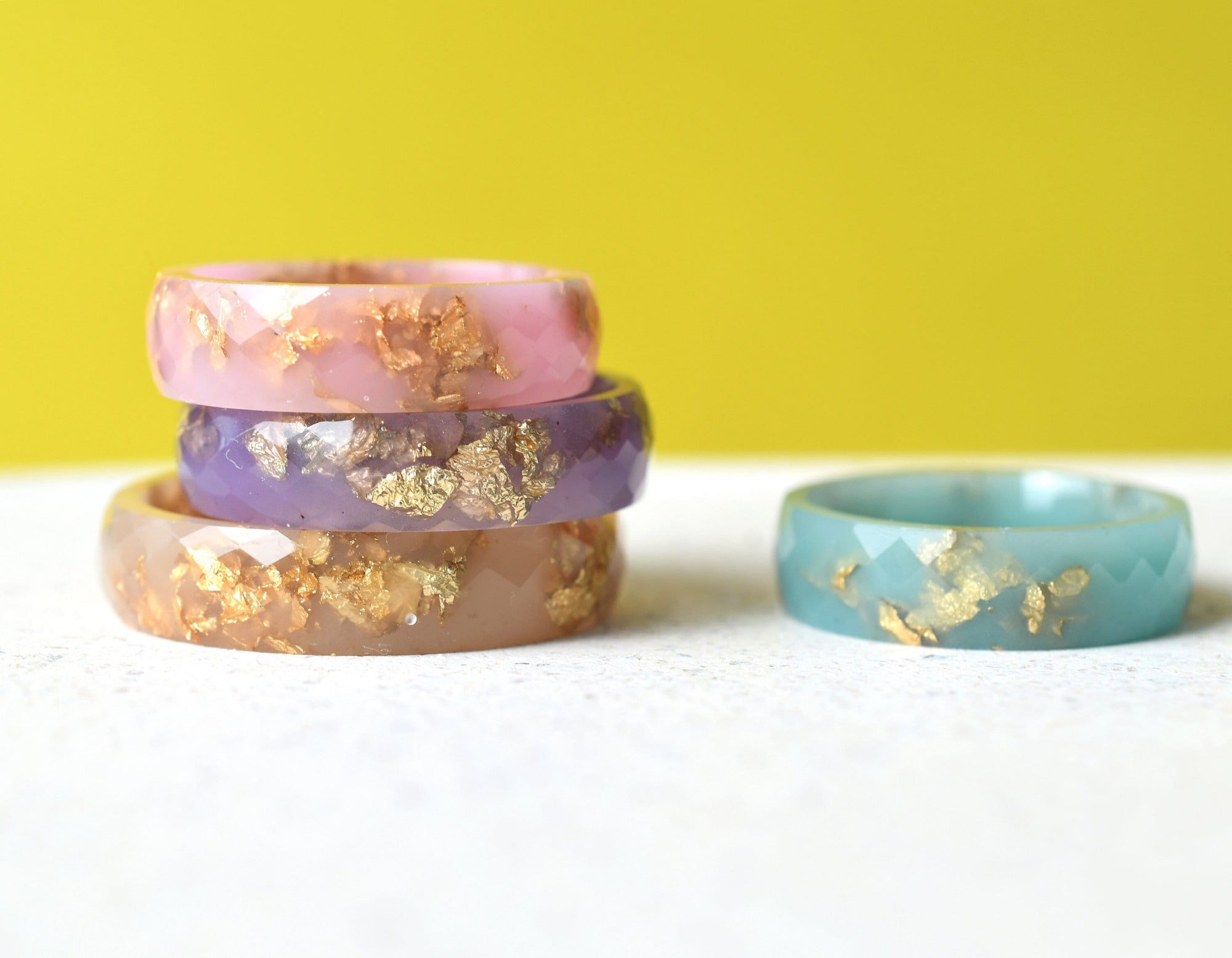 Pastel resin rings with gold leaf handmade by Resity in Vienna — pink, blue, purple, and nude