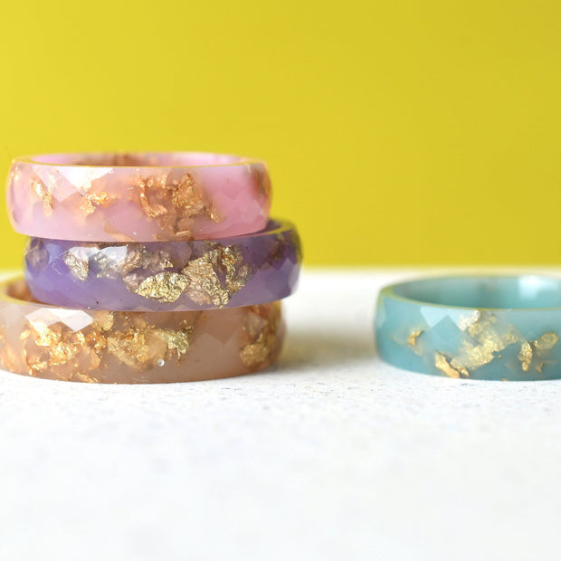 Pastel resin rings with gold leaf handmade by Resity in Vienna — pink, blue, purple, and nude