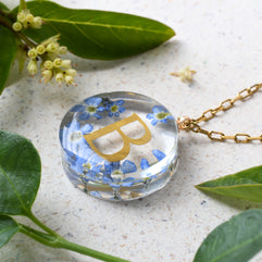 Personalized resin necklace with forget-me-not flowers and gold initial