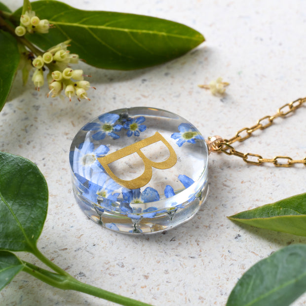 Personalized resin necklace with forget-me-not flowers and gold initial