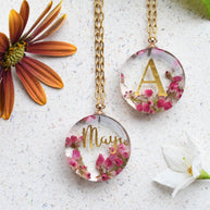 Close-up of real heather flowers and printed name embedded in clear resin