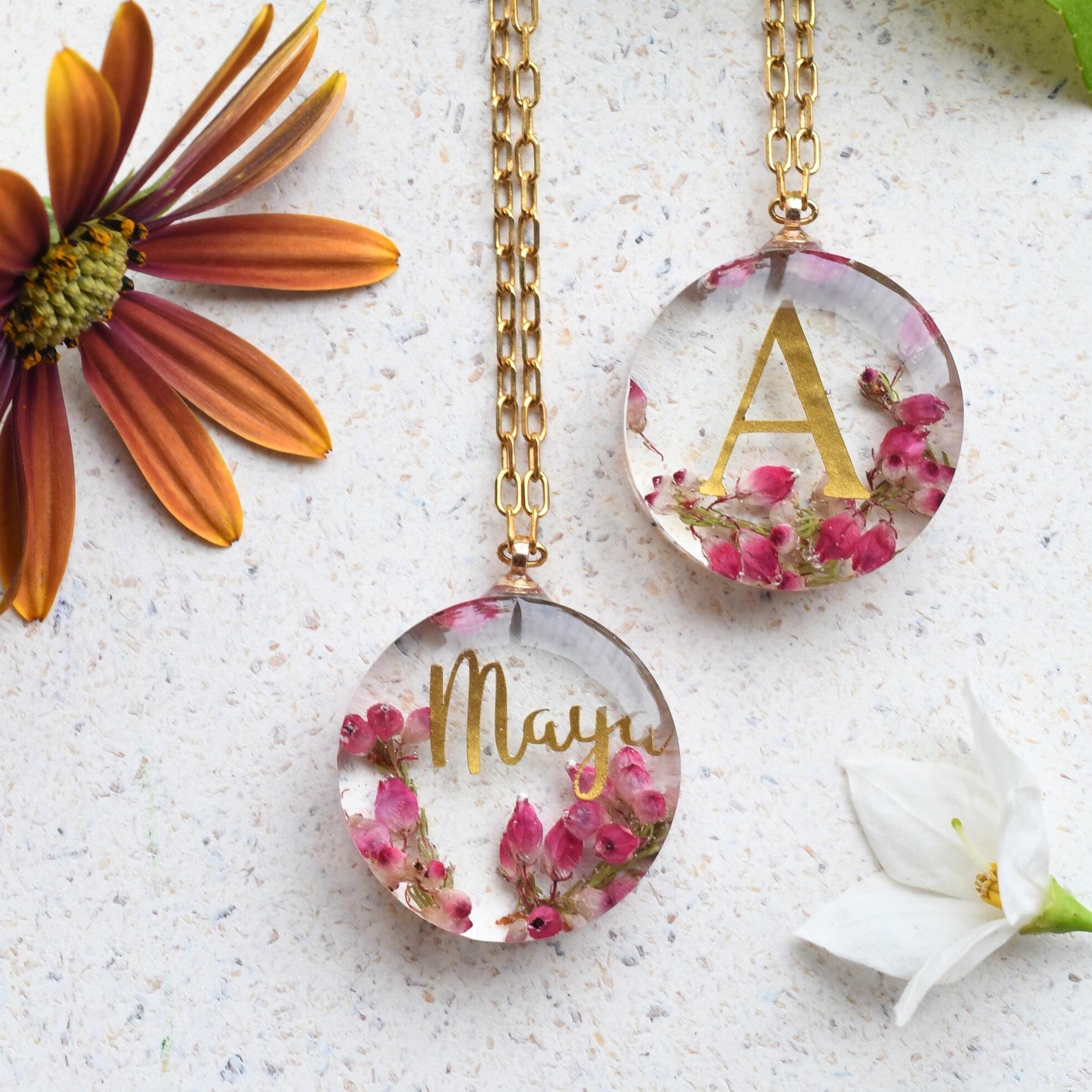 Close-up of real heather flowers and printed name embedded in clear resin