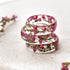 Stack of clear resin rings with pink heather flowers on a light surface