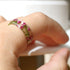 Hand model wearing pink heather resin ring, showcasing natural floral detail
