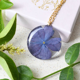 Real purple hydrangea flower encased in clear resin pendant