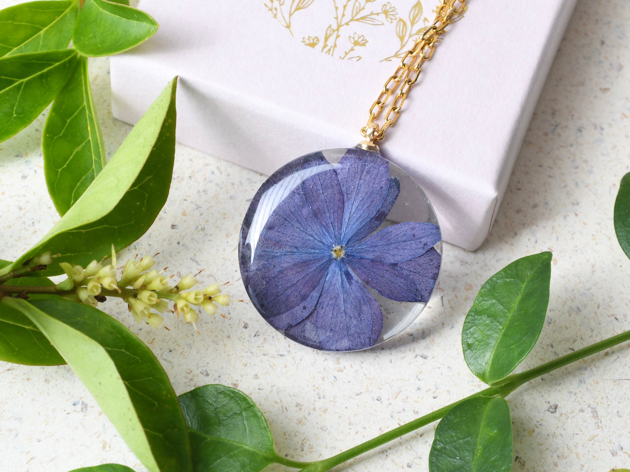 Real purple hydrangea flower encased in clear resin pendant