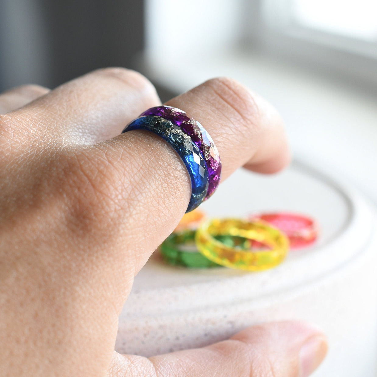 Close-up of gold leaf flakes inside rainbow resin — handcrafted ring by Resity