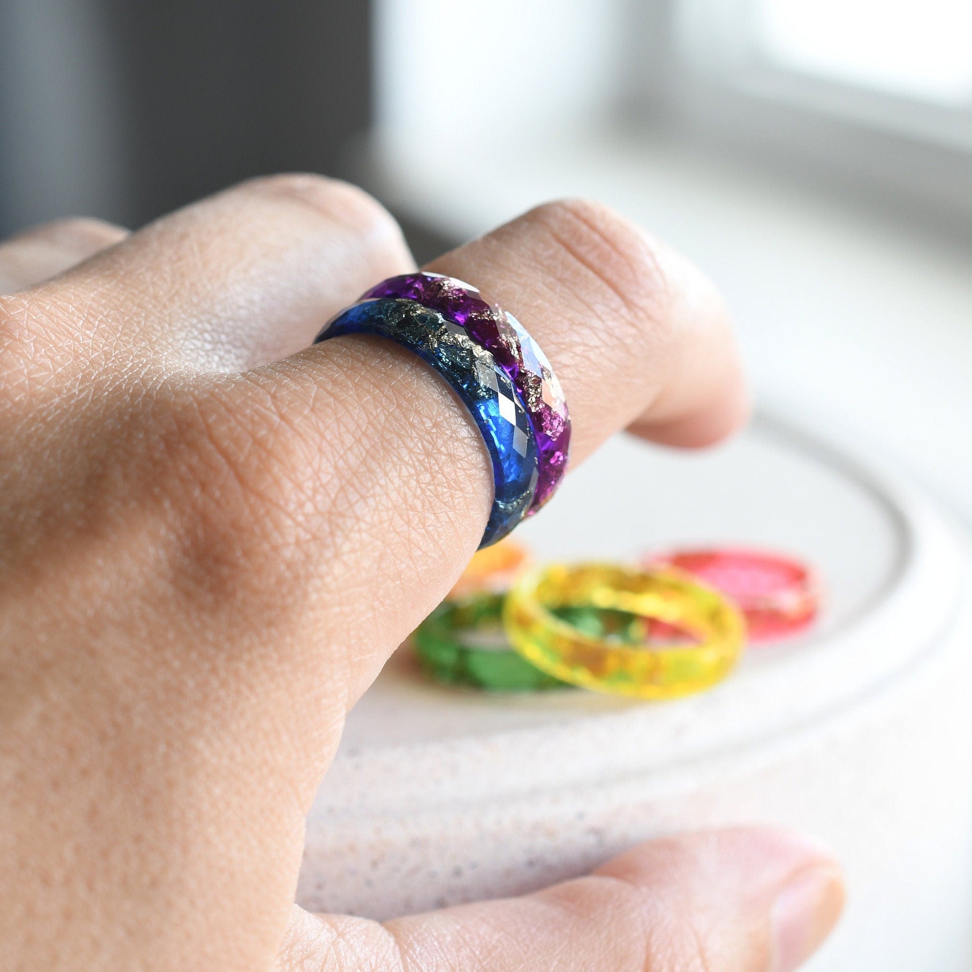 Close-up of gold leaf flakes inside rainbow resin — handcrafted ring by Resity