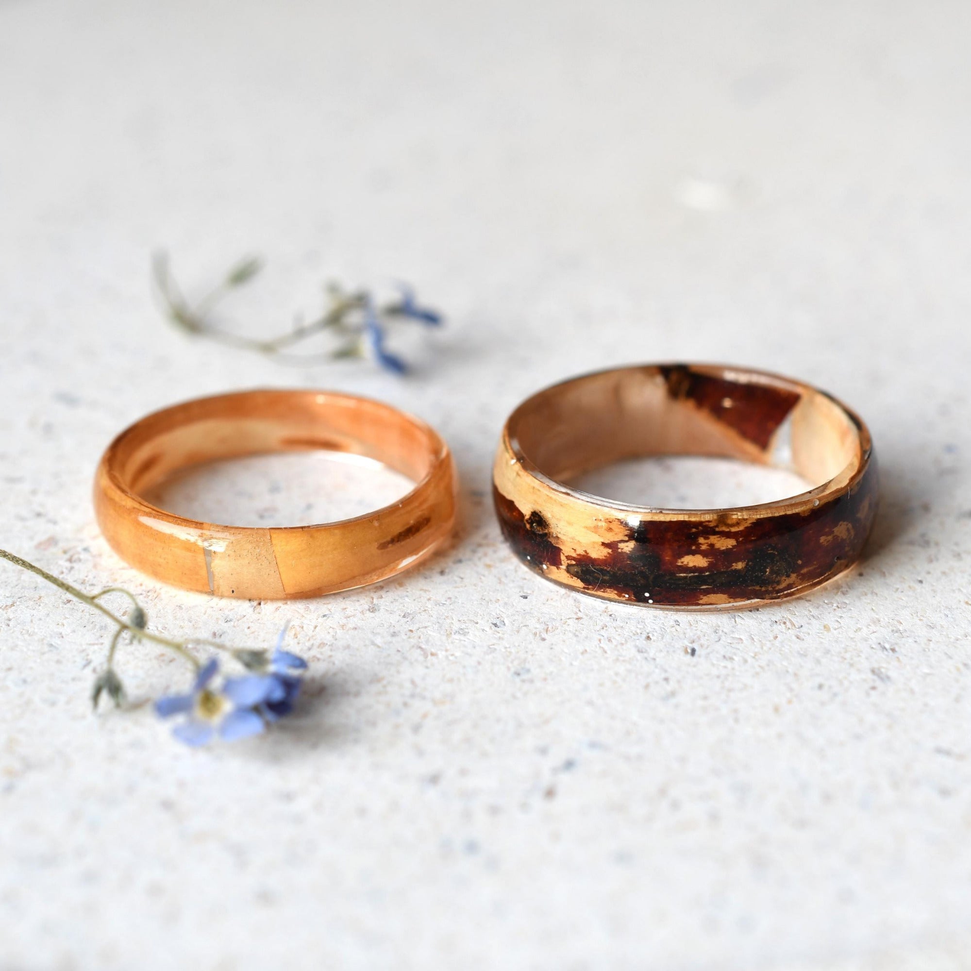 Close-up of natural birch wood texture encased in clear resin handmade rings