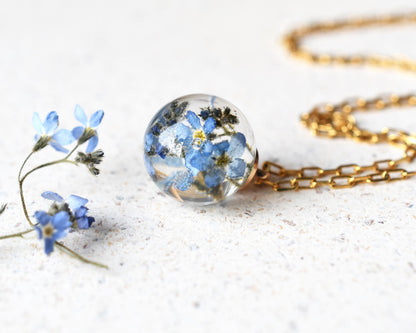 Real forget-me-not pendant in clear resin on white