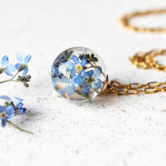 Real forget-me-not pendant in clear resin on white