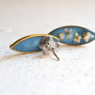 Close-up of real alyssum blossoms in clear blue resin handmade by Resity