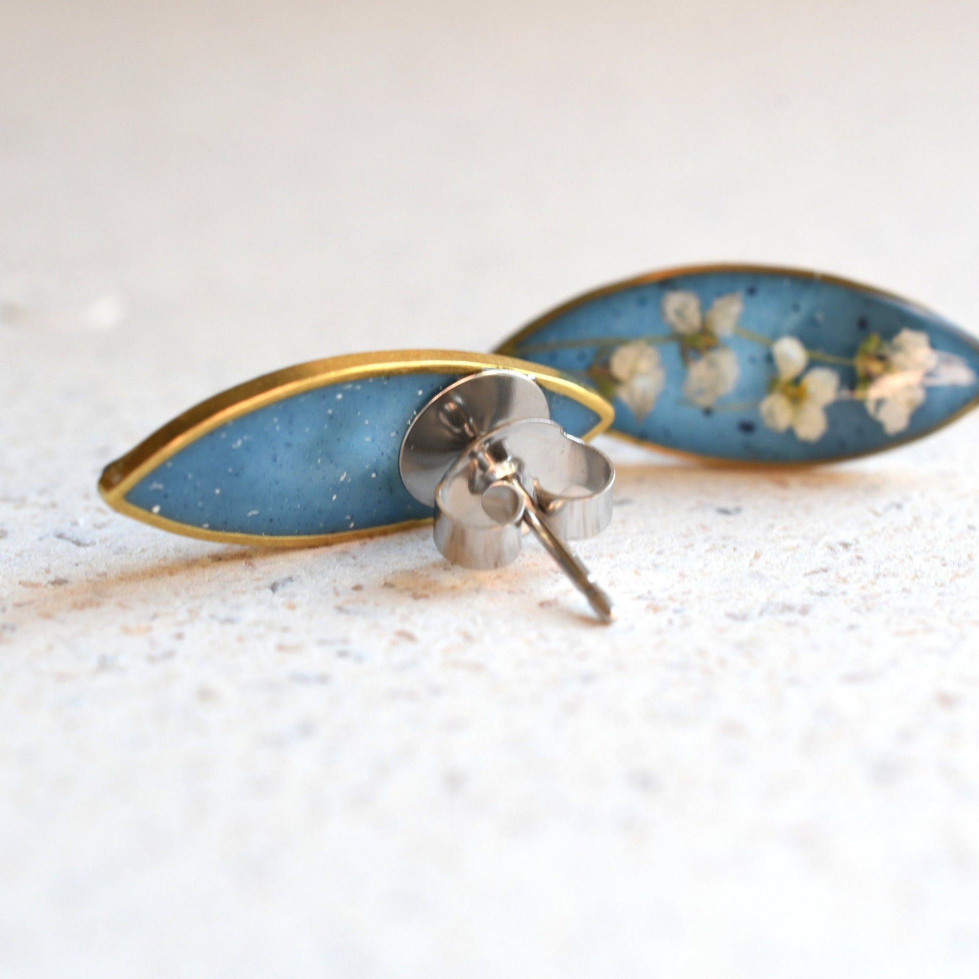 Close-up of real alyssum blossoms in clear blue resin handmade by Resity