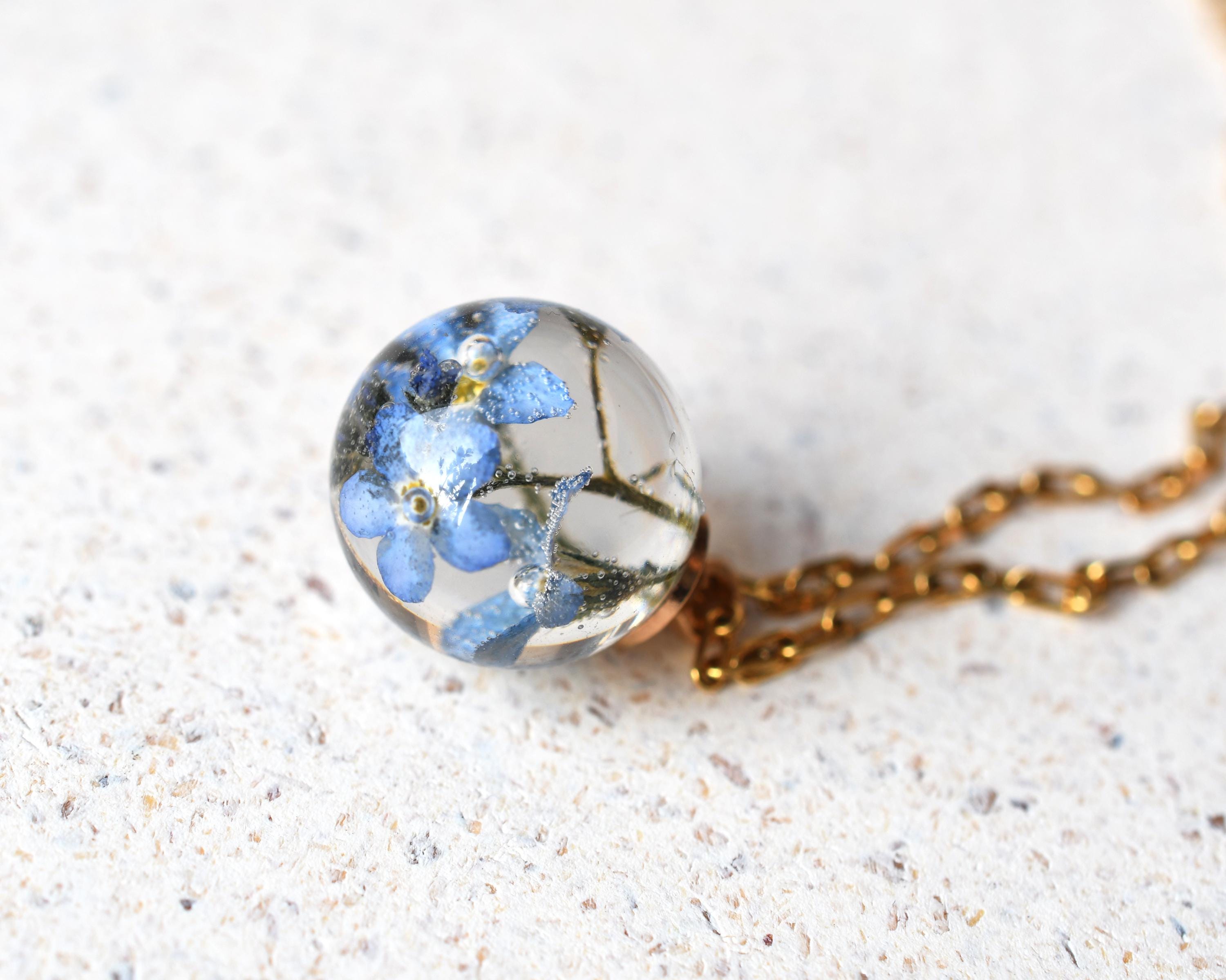 Close-up of preserved flower in spherical resin charm
