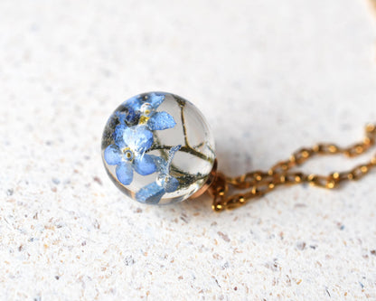 Close-up of preserved flower in spherical resin charm