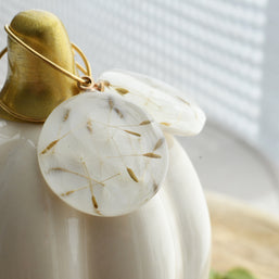 Resin dangle earrings with gold creole hoops and embedded dandelion seeds, handmade lightweight jewelry