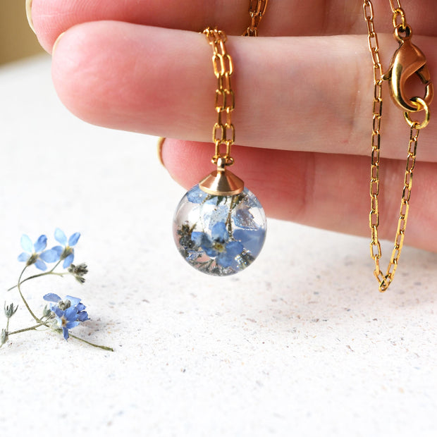 Hand holding pendant for size reference