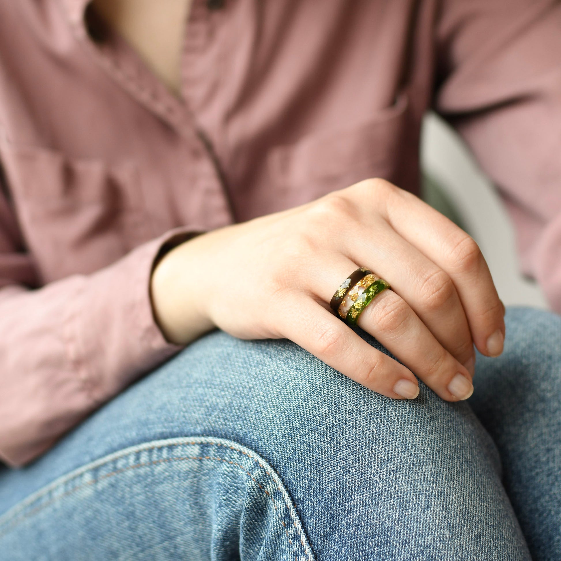 Resin stacking rings with gold flakes worn on hand