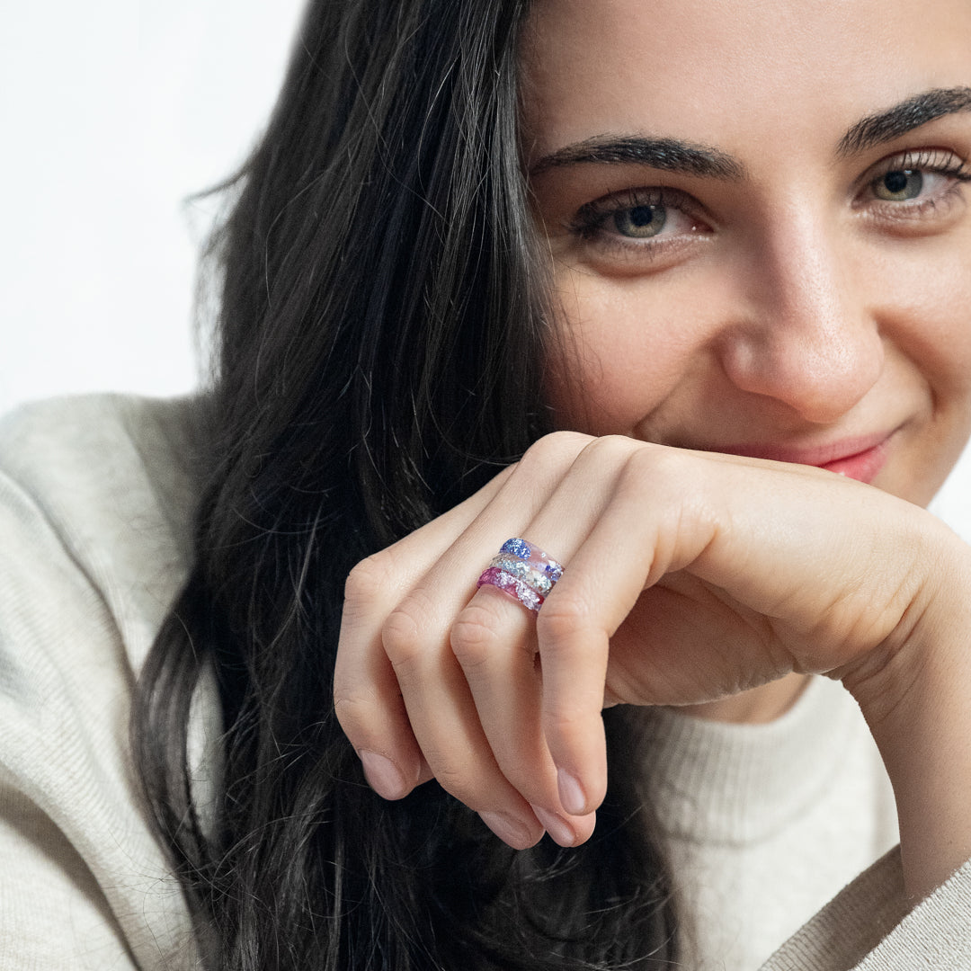 Resin stacking rings with silver flakes worn on hand