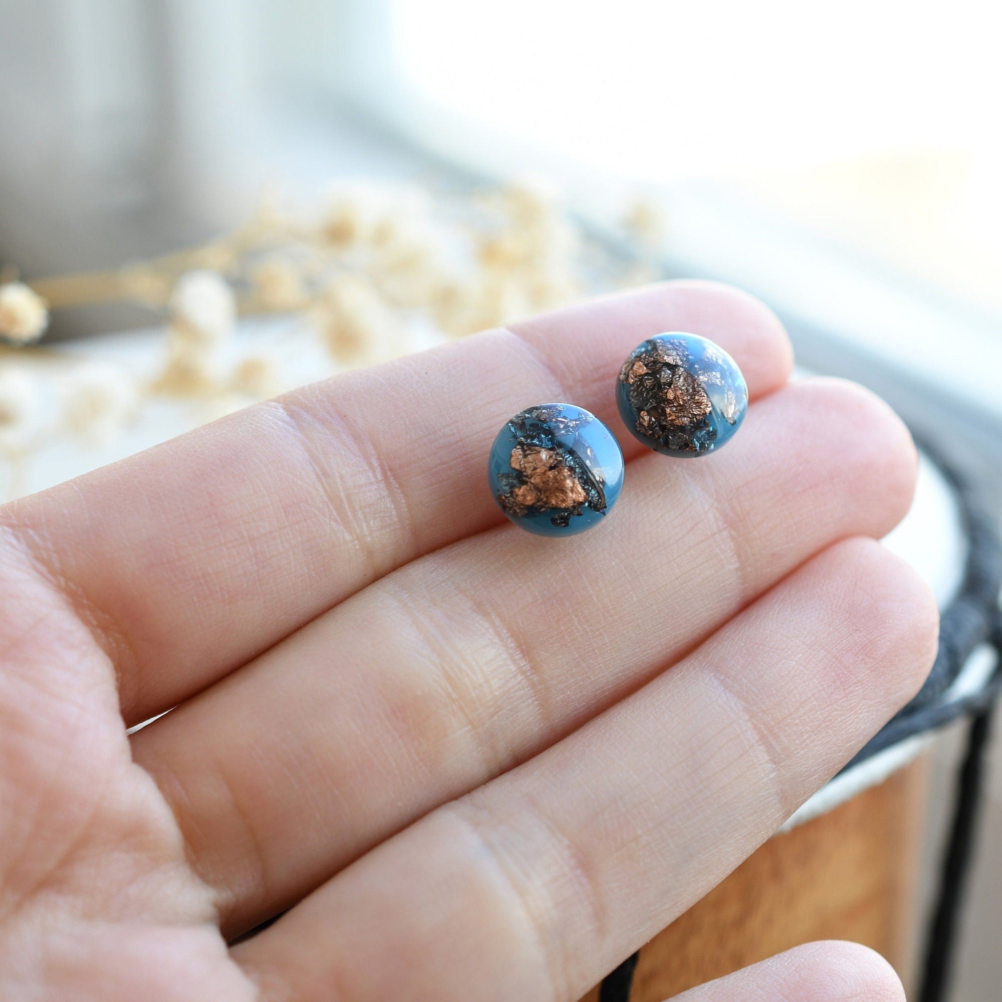 Blue resin stud earrings with rose gold flakes on hypoallergenic surgical-steel posts