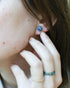Blue and gold resin stud earrings worn on ear — hypoallergenic handmade jewelry
