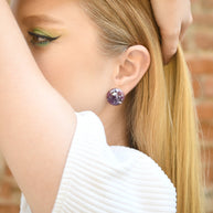 Lavender resin stud earrings worn on ear — minimal and elegant design