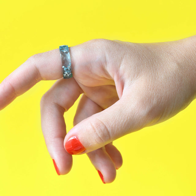 Aquamarine resin ring with silver flakes worn on hand — unisex minimalist jewelry