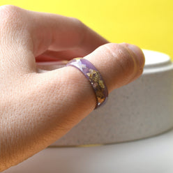 Stack of pastel resin rings worn on hand — minimalist everyday jewelry