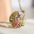 Moss and pink crystal resin necklace in sunlight