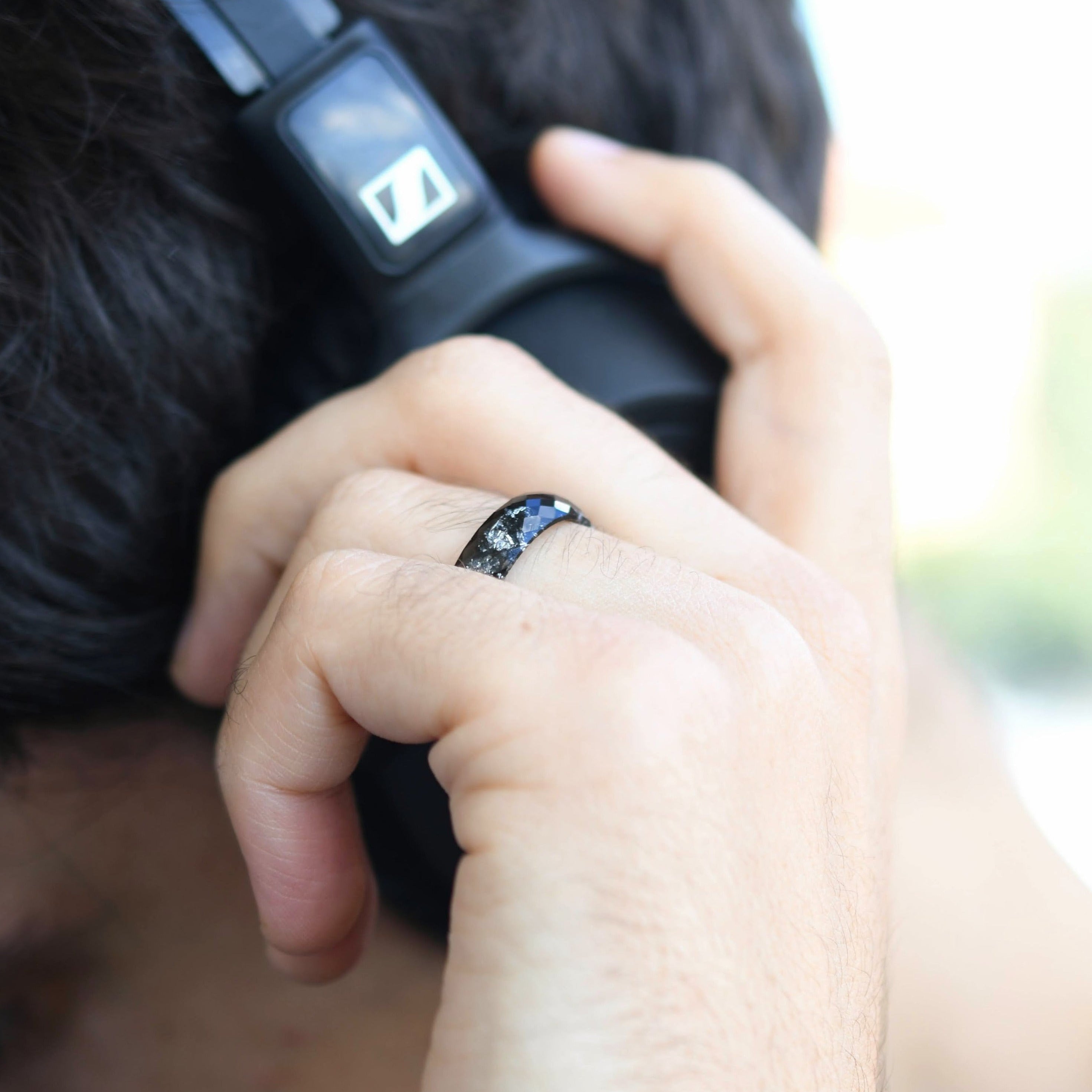 Black resin ring with silver flakes worn on hand — unisex minimalist jewelry